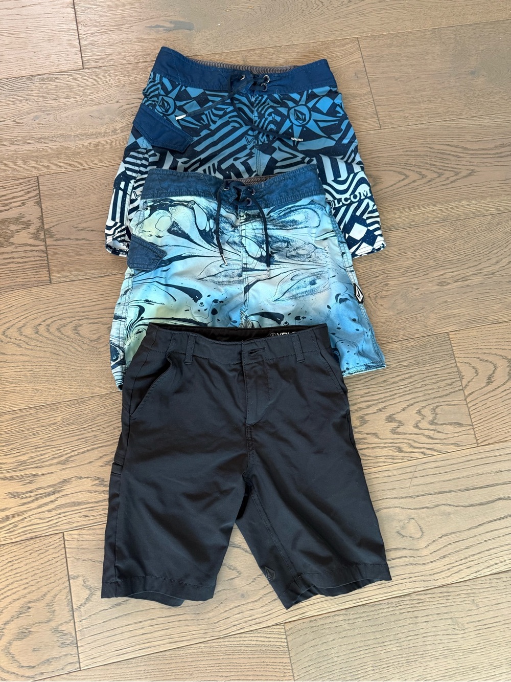 Volcom kids swim board shorts and black shorts lot of 3. Size 24 boys.